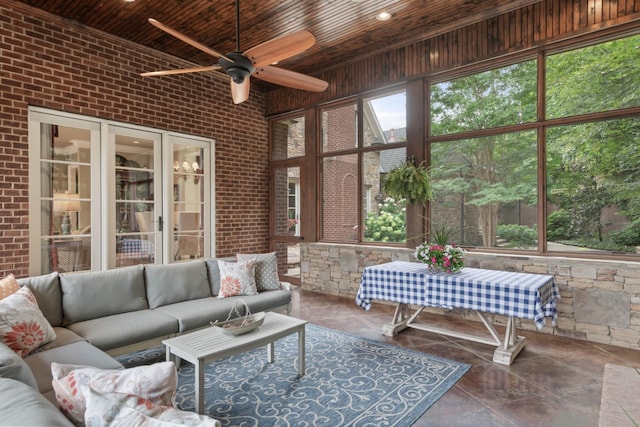 sunroom with ceiling fan and wooden ceiling