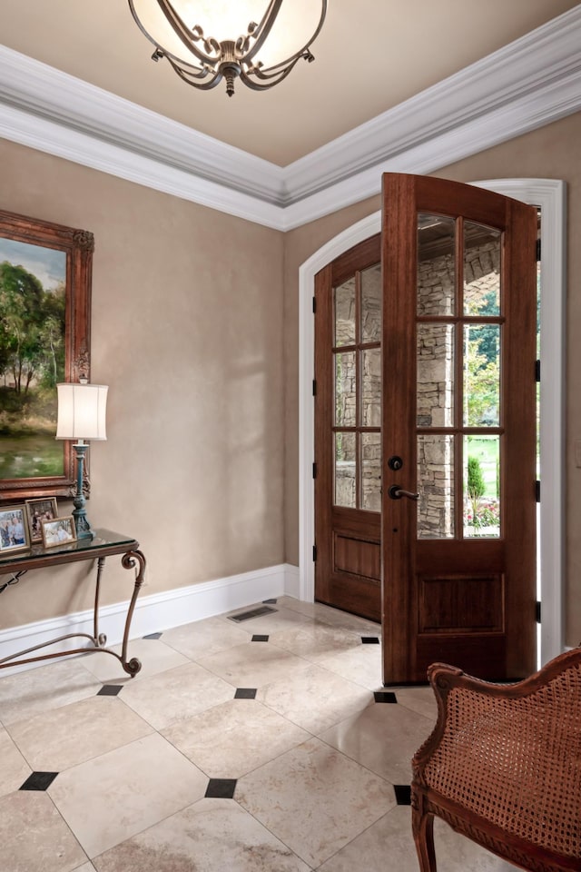 entryway featuring ornamental molding and french doors