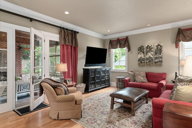 living room featuring hardwood / wood-style flooring and ornamental molding