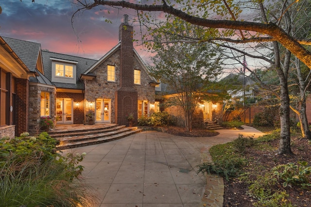 view of front facade with french doors and a patio