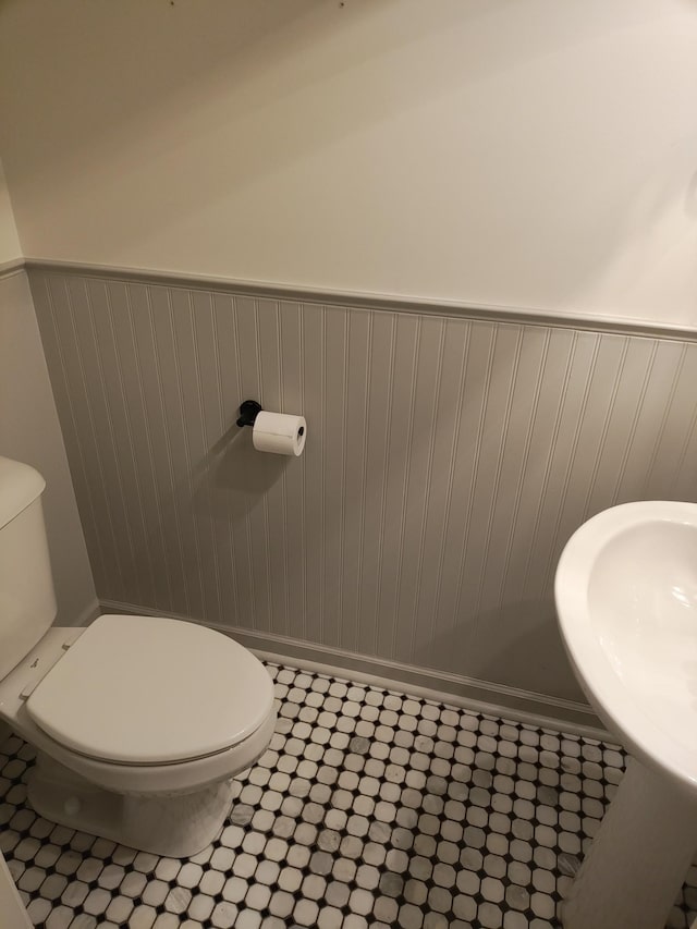 bathroom with sink, tile patterned flooring, and toilet