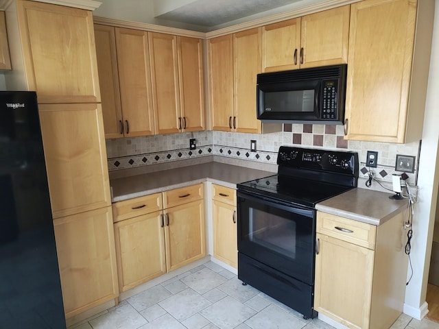 kitchen featuring light brown cabinetry, black appliances, and decorative backsplash