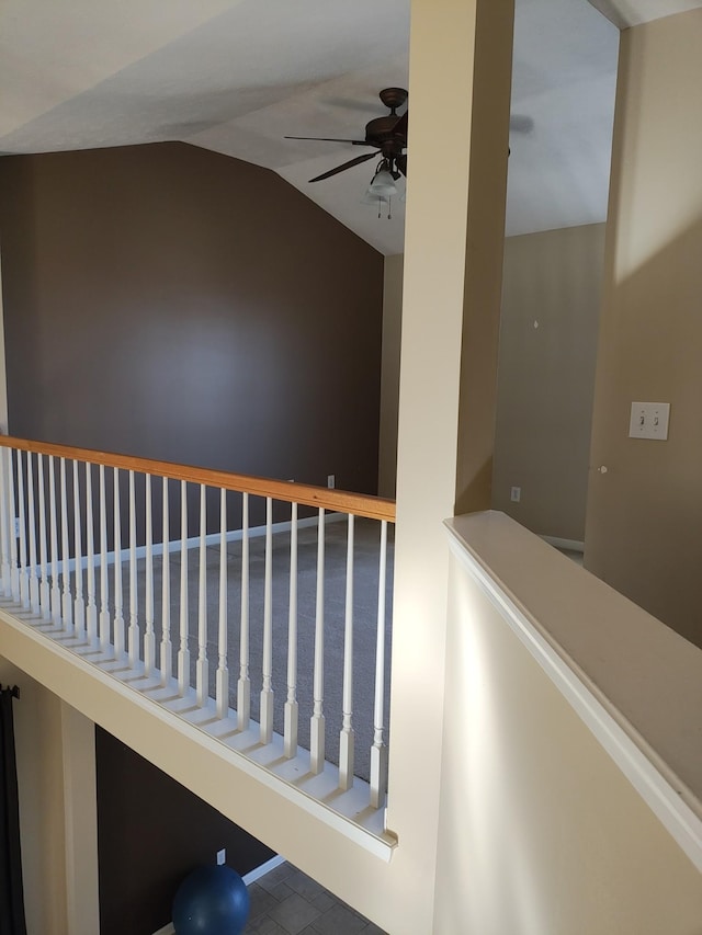 staircase featuring lofted ceiling and ceiling fan