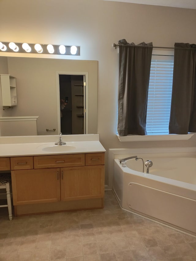 bathroom featuring vanity and a bath