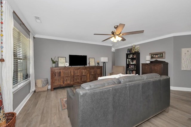 living room featuring light wood-type flooring, ceiling fan, and ornamental molding