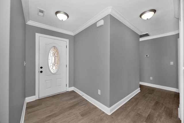 foyer entrance with dark wood-type flooring and ornamental molding