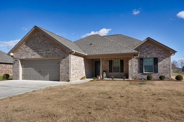 view of front of property with a front lawn and a garage