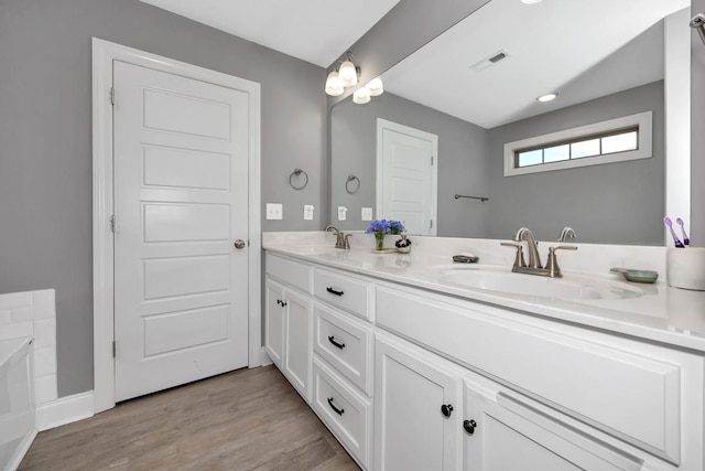 bathroom with vanity and hardwood / wood-style flooring