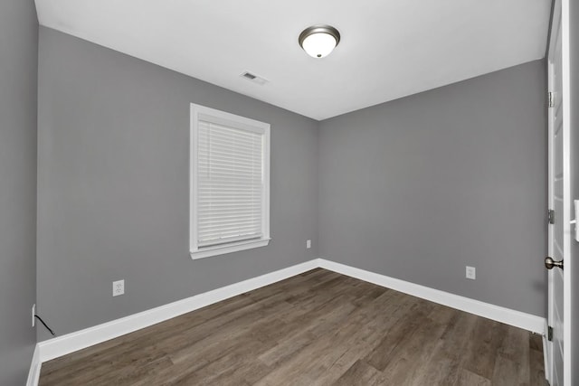 unfurnished room featuring dark hardwood / wood-style floors