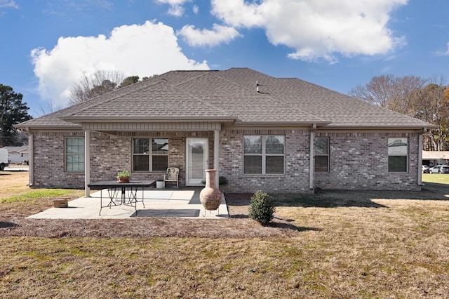 rear view of property featuring a lawn and a patio