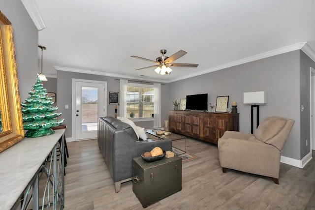 living room featuring light hardwood / wood-style floors, ceiling fan, and ornamental molding