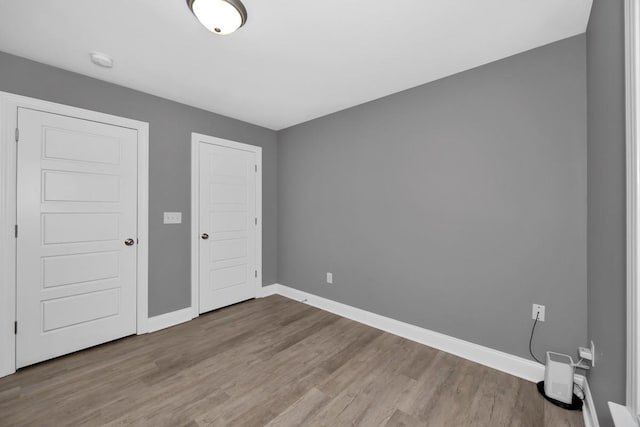 unfurnished bedroom with hardwood / wood-style flooring