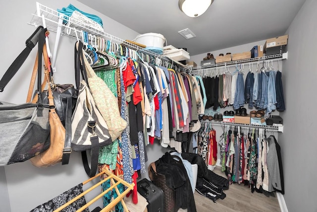 spacious closet featuring hardwood / wood-style flooring