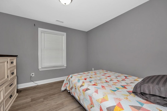 bedroom with hardwood / wood-style flooring