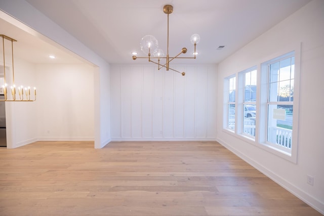 interior space featuring a notable chandelier and light hardwood / wood-style flooring