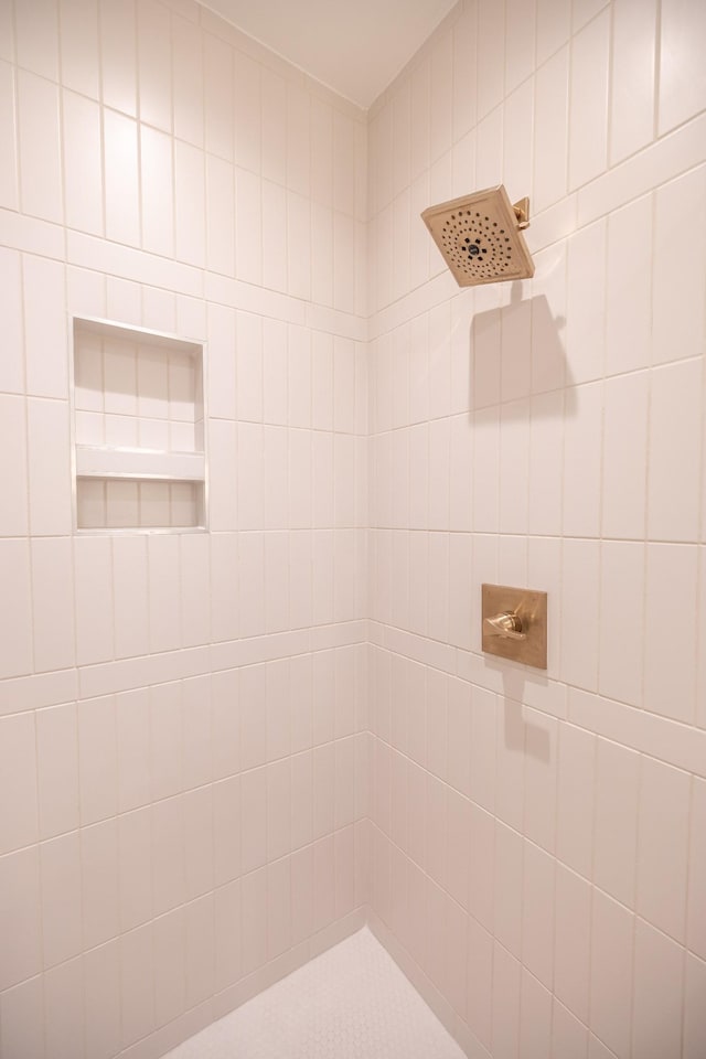 bathroom with a tile shower