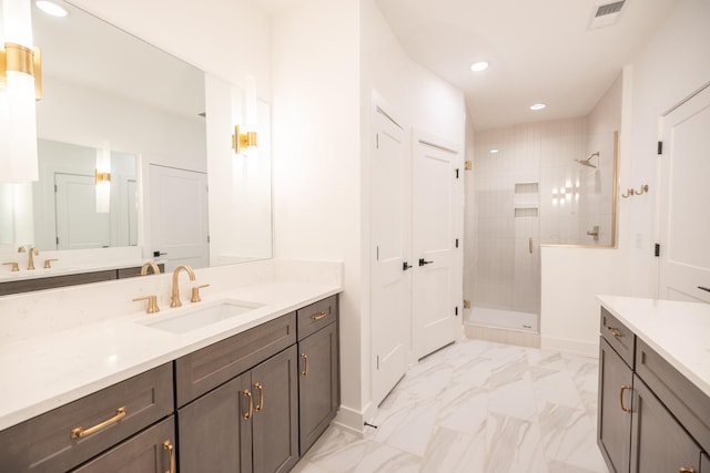 bathroom featuring vanity and a shower with shower door