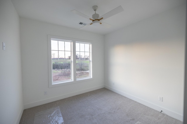 empty room featuring carpet flooring and ceiling fan