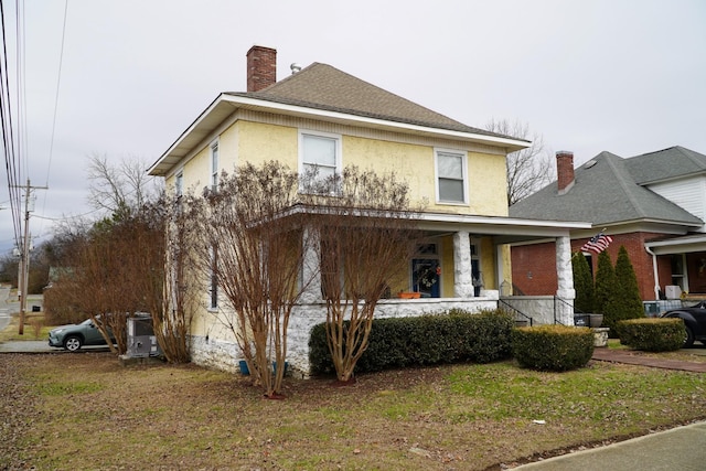 view of front of property with a front yard and a porch