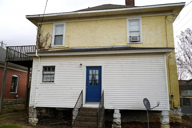 back of house featuring a balcony and cooling unit