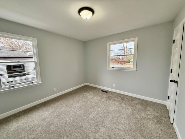 carpeted empty room with plenty of natural light