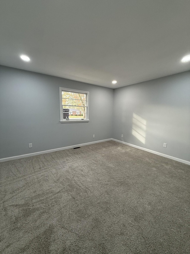 spare room featuring recessed lighting, carpet flooring, and baseboards