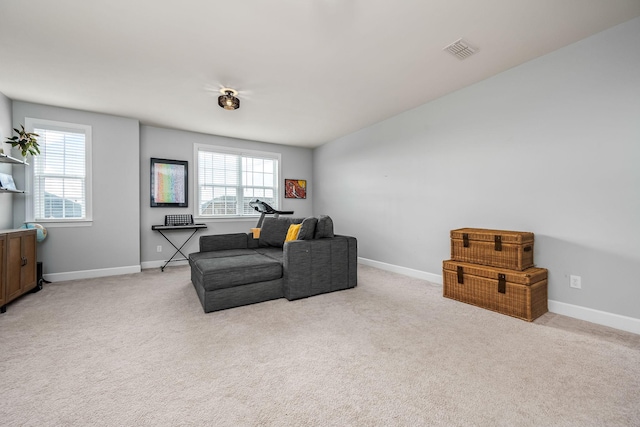 living area with light colored carpet and a wealth of natural light