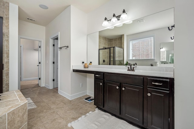 bathroom featuring tile patterned flooring, vanity, and an enclosed shower