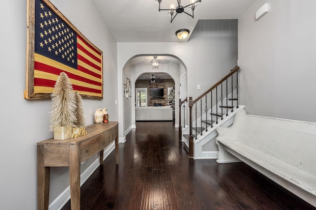 entrance foyer featuring a chandelier and dark wood-type flooring