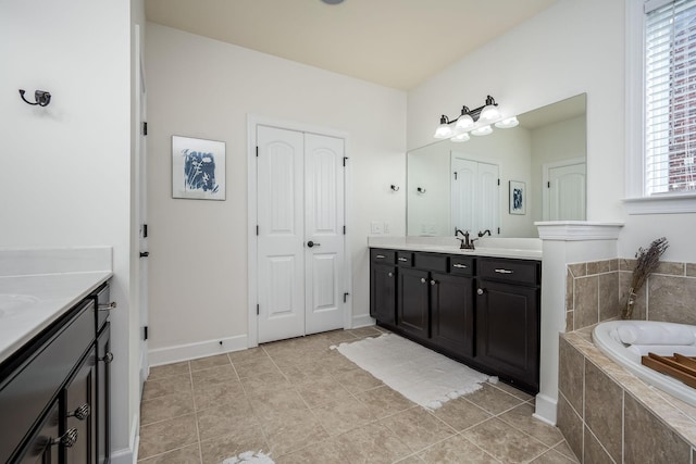 bathroom with tile patterned flooring, vanity, and a wealth of natural light