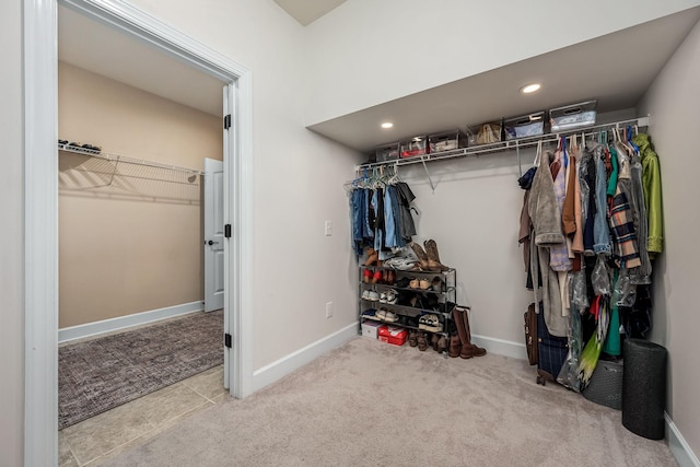 walk in closet with carpet floors