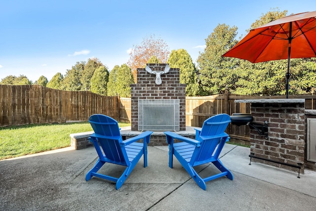 view of patio featuring an outdoor brick fireplace