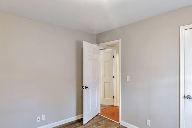 unfurnished bedroom with dark hardwood / wood-style floors