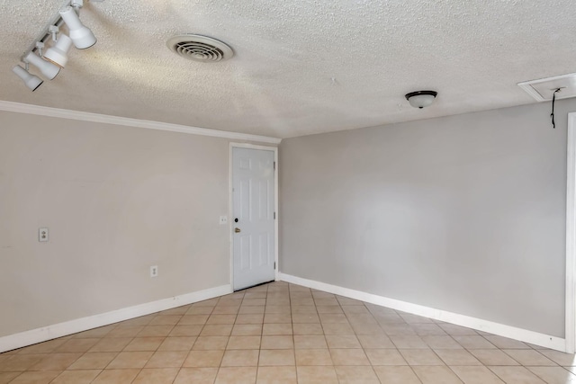 spare room featuring light tile patterned floors, a textured ceiling, and ornamental molding