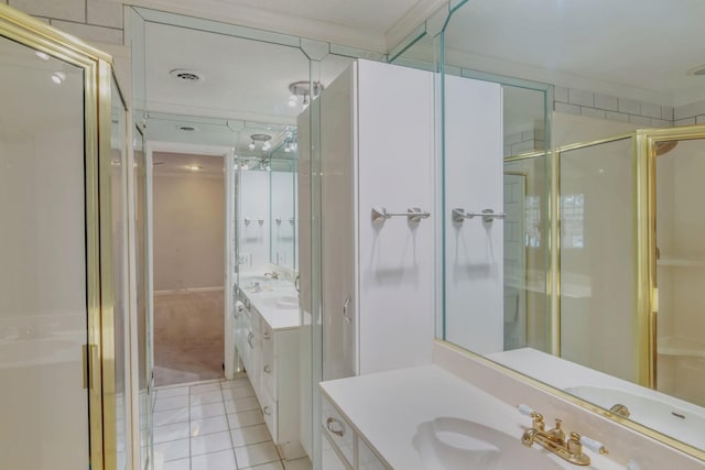 bathroom featuring tile patterned flooring, vanity, a shower with shower door, and crown molding