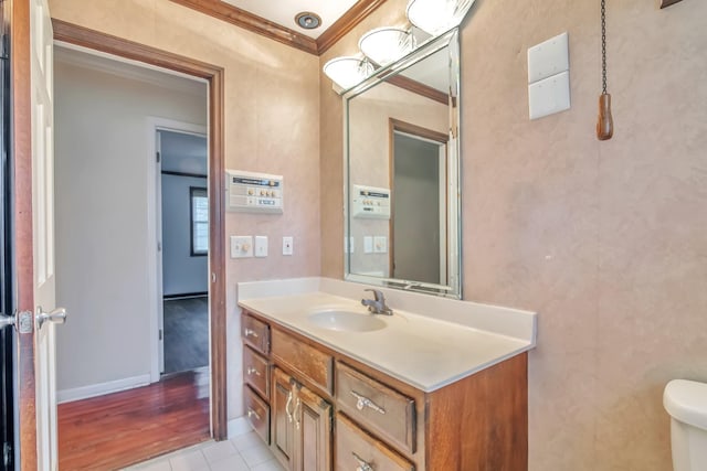 bathroom featuring hardwood / wood-style flooring, vanity, toilet, and crown molding