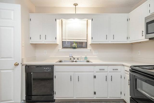 kitchen with sink, white cabinets, black appliances, and a textured ceiling