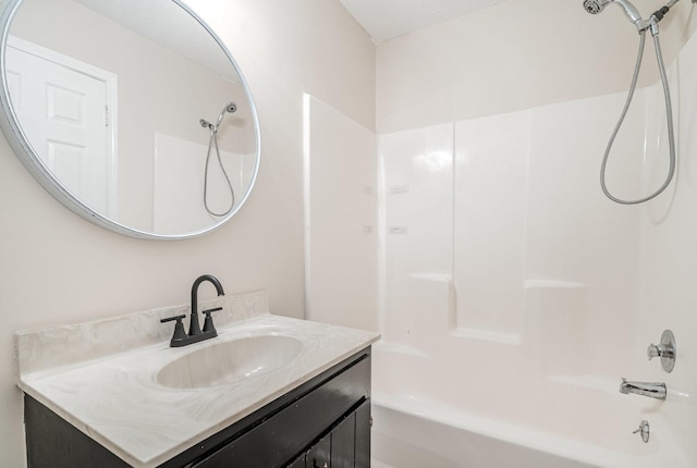 bathroom featuring vanity and  shower combination