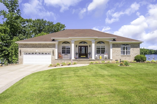 mediterranean / spanish home featuring a front lawn, a porch, and a garage