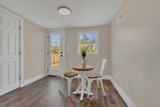 dining space with dark hardwood / wood-style flooring