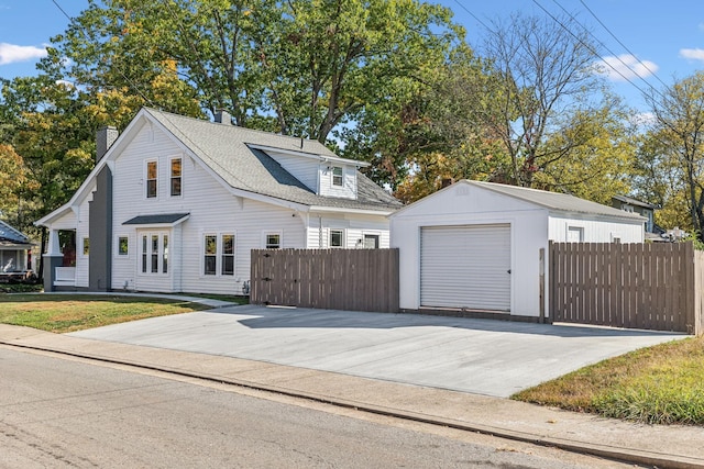 view of front of property featuring an outdoor structure and a garage