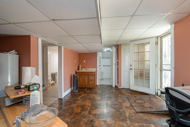 office space featuring sink and a paneled ceiling