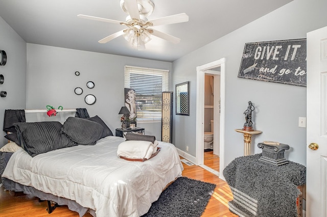 bedroom featuring connected bathroom, hardwood / wood-style flooring, and ceiling fan