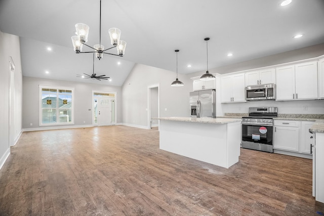 kitchen with appliances with stainless steel finishes, open floor plan, a center island, hanging light fixtures, and white cabinetry