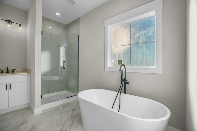 full bathroom with visible vents, baseboards, vanity, a freestanding tub, and a shower stall