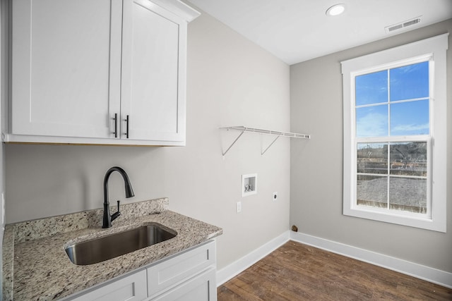 washroom featuring washer hookup, dark wood finished floors, a sink, electric dryer hookup, and baseboards