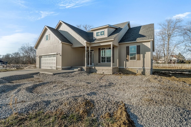 view of front of property featuring an attached garage, a shingled roof, fence, and concrete driveway