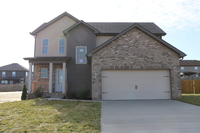 view of property featuring a garage and a front lawn