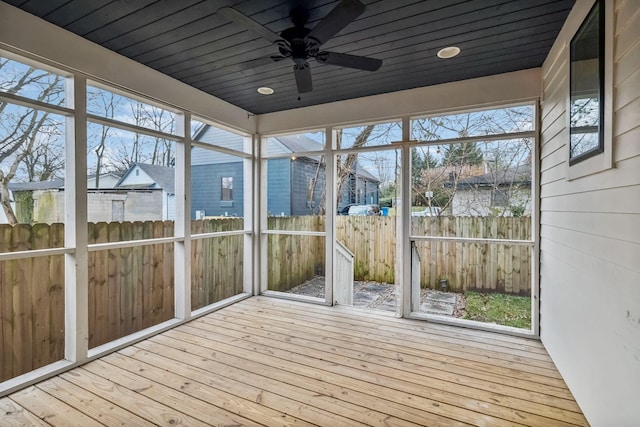 unfurnished sunroom featuring ceiling fan and wooden ceiling