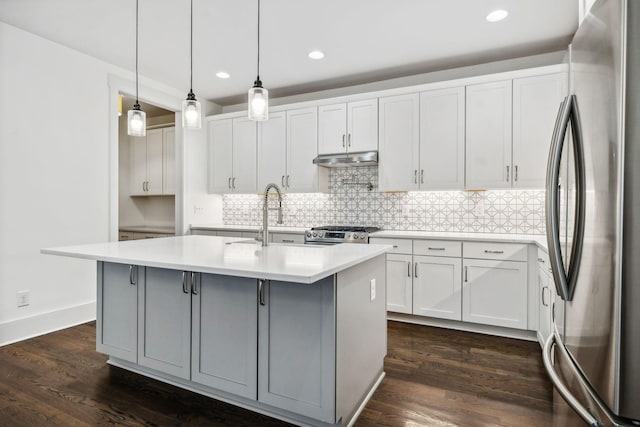 kitchen with a kitchen island with sink, white cabinets, stainless steel appliances, and dark hardwood / wood-style floors